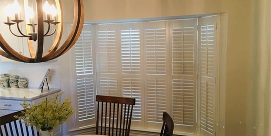 SL 300 vinyl shutters installation in a bay window.